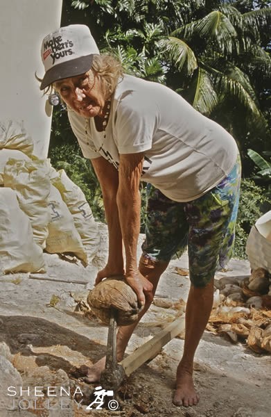 Erlene Downie splitting Coconuts.jpg - Erlene splitting open coconuts